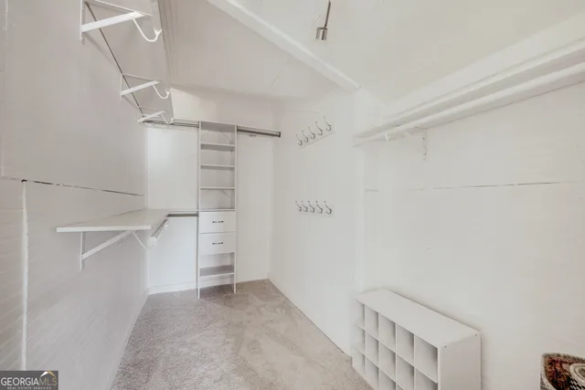 a view of a patio with table and chairs potted plants and a large tree