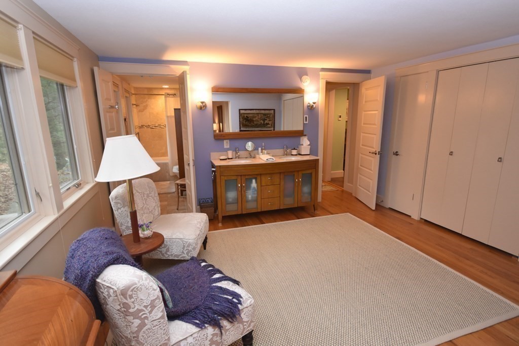 32 Aubinwood Road Amherst, MA 01002 - Photo 22 of 42 a living room with furniture a fireplace and a flat screen tv