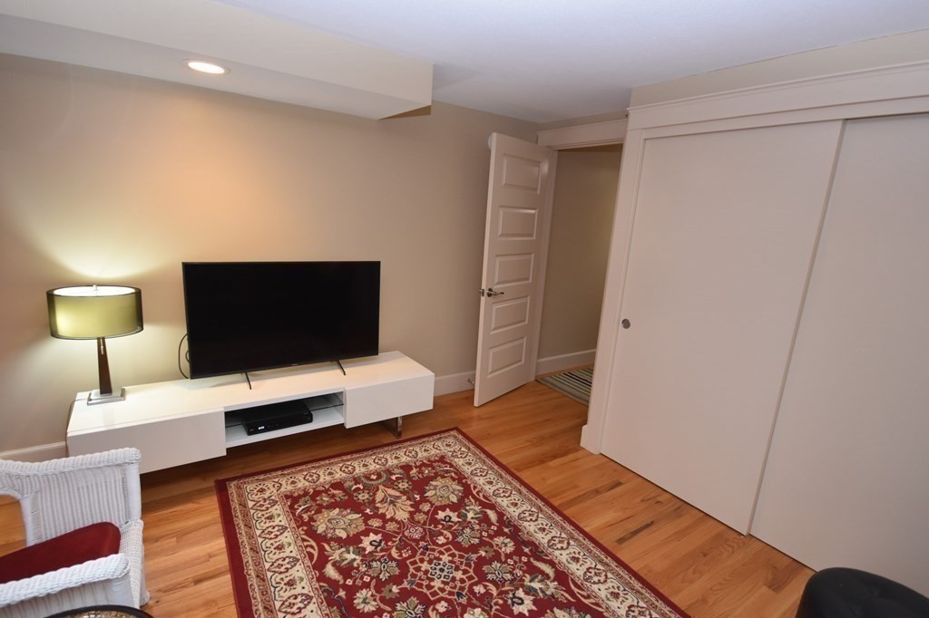 32 Aubinwood Road Amherst, MA 01002 - Photo 27 of 42 a bedroom with a bed and a flat screen television