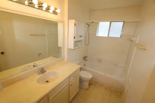 a bathroom with a tub sink toilet and a shower