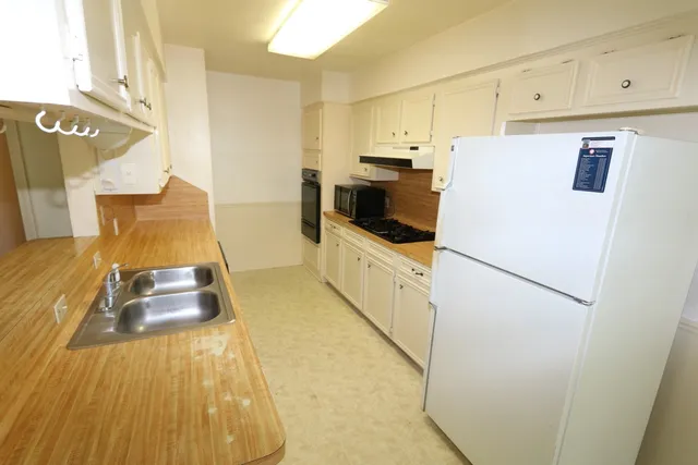 a white refrigerator freezer sitting inside of a kitchen