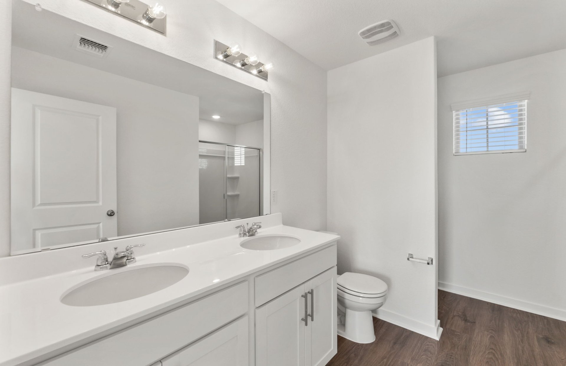 590 Rubber Tree Way Buda, TX 78610 - Photo 8 of 22 a bathroom with a granite countertop toilet a sink and a mirror