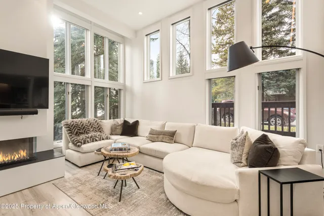 a living room with furniture fireplace and flat screen tv