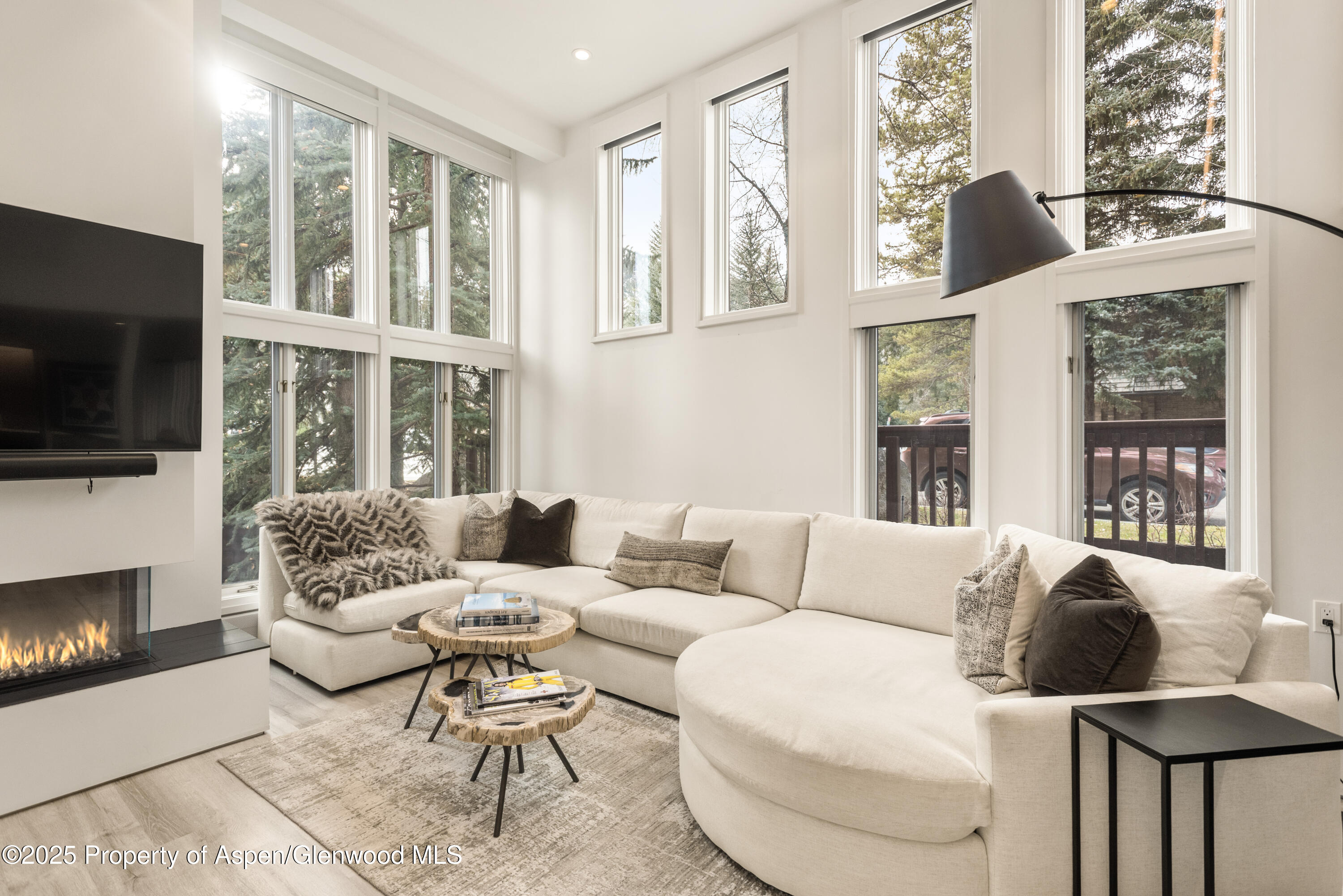 a living room with furniture fireplace and flat screen tv