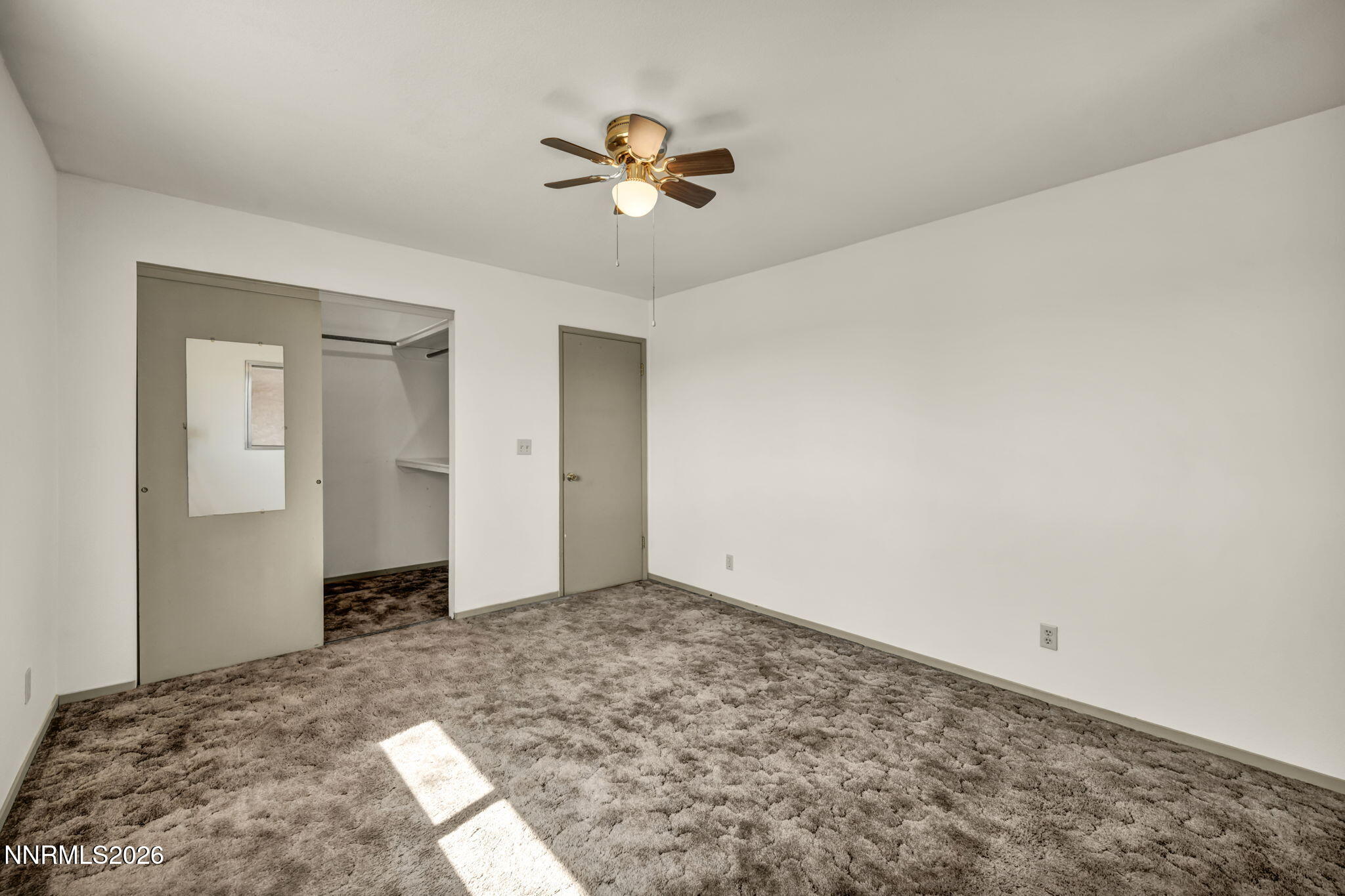 5250 Stillwater Road Fallon, NV 89406 - Photo 21 of 53 a view of a livingroom with a chandelier fan and closet area