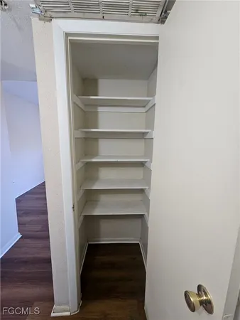 a view of walk in closet with empty racks