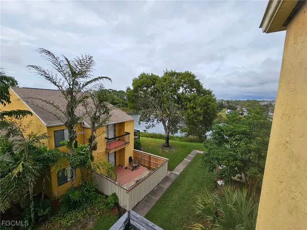 a view of house with garden space and trees