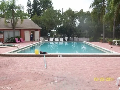 a view of a house with swimming pool and a yard