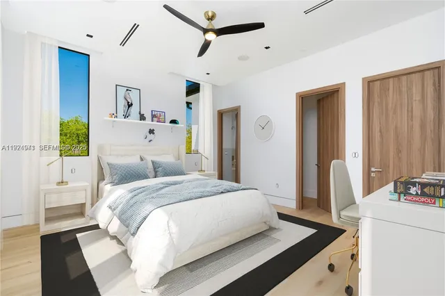 a bedroom with a bed wooden floor and window