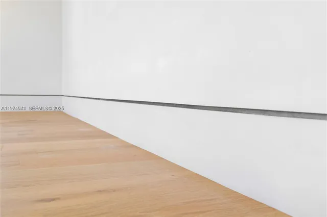 a bedroom with furniture and a large window