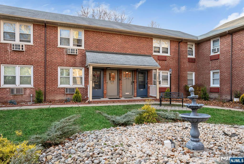 16-08 Plaza Road, Unit B Fair Lawn, NJ 07410 - Photo 3 of 16 a front view of a house with a yard and porch