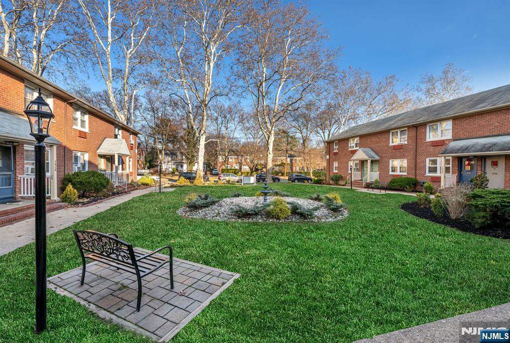 16-08 Plaza Road, Unit B Fair Lawn, NJ 07410 - Photo 4 of 16 a view of a chair and table in backyard of the house