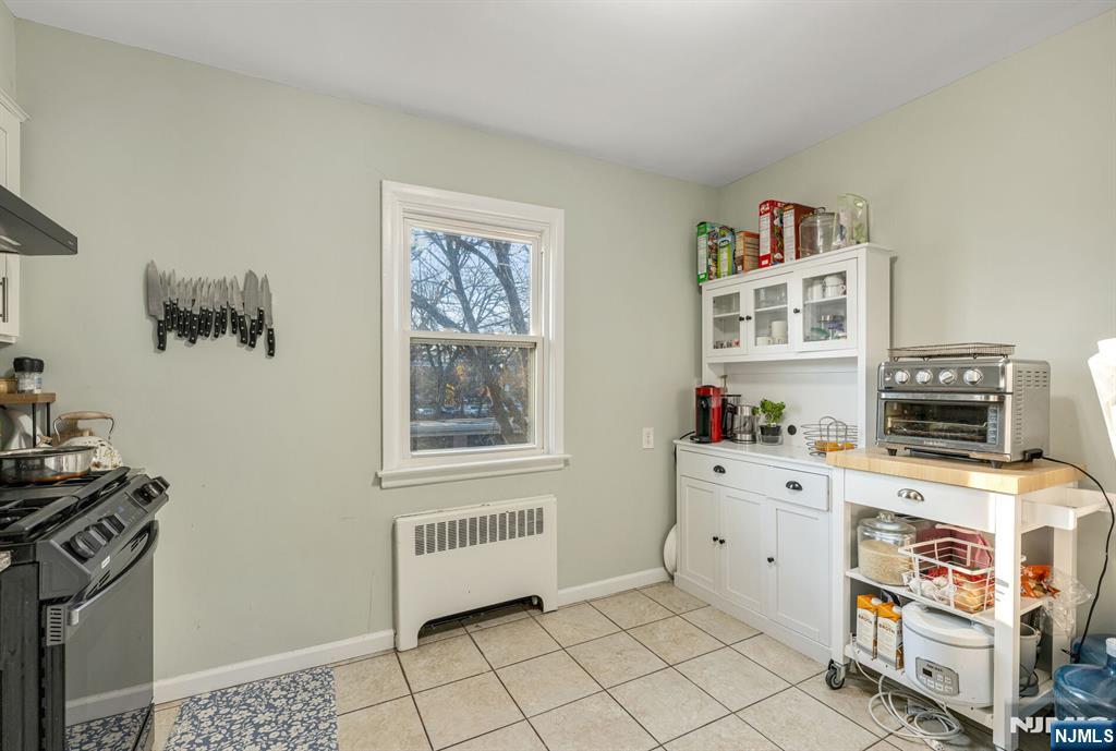 16-08 Plaza Road, Unit B Fair Lawn, NJ 07410 - Photo 10 of 16 a room with furniture and a stove top oven