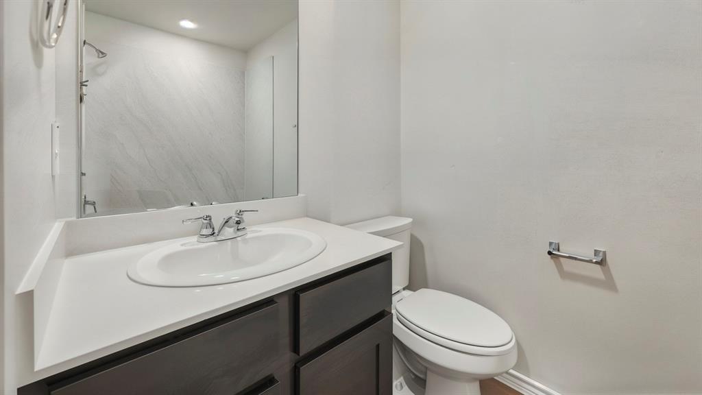 1908 Freeman Street Tyler, TX 75704 - Photo 28 of 30 Bathroom vanity featuring a white oval sink, chrome faucet, and white countertop