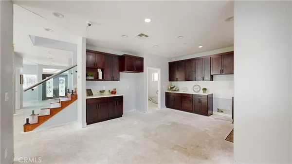 a kitchen with stainless steel appliances granite countertop a refrigerator sink and cabinets