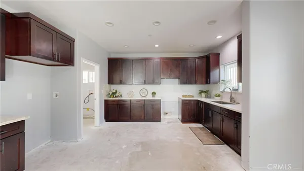 a kitchen with cabinets and stainless steel appliances