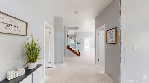 a view of entryway with paintings on the wall