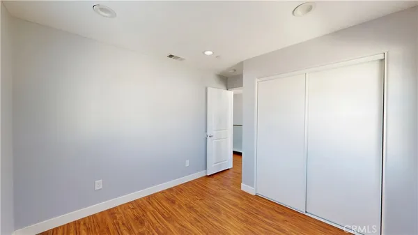 a view of a room with wooden floor and a window