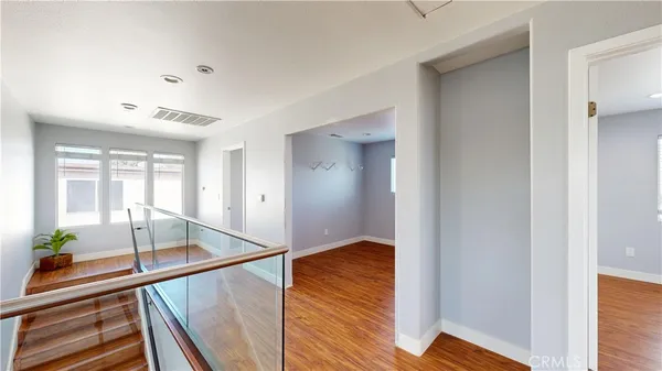 a view of empty room with wooden floor