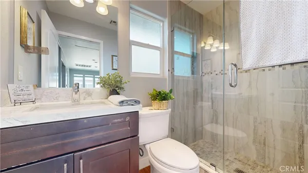 a spacious bathroom with a double vanity sink toilet and shower