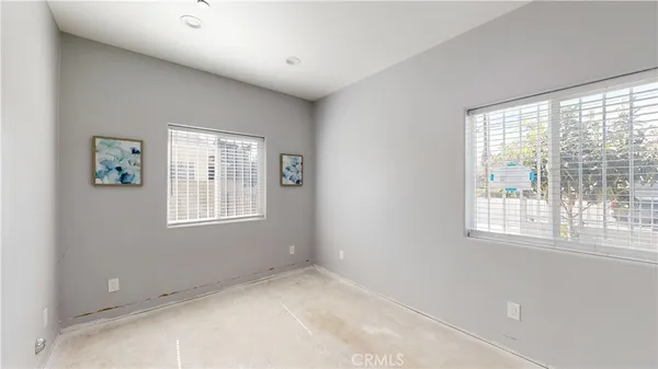 a view of a room that has a window and a ceiling fan
