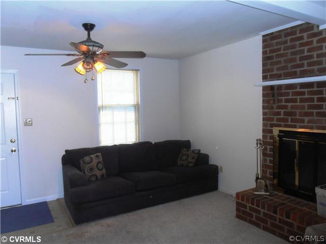 4901 Rollingway Road Chesterfield, VA 23832 - Photo 7 of 14 a living room with couches a fireplace and a window