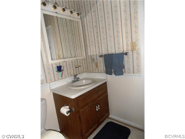 4901 Rollingway Road Chesterfield, VA 23832 - Photo 8 of 14 a bathroom with a sink vanity and mirror