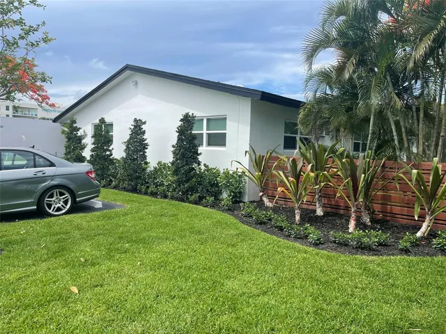 a view of a house with a car parked in front of a house
