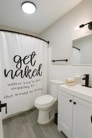 a bathroom with a sink a toilet and a mirror