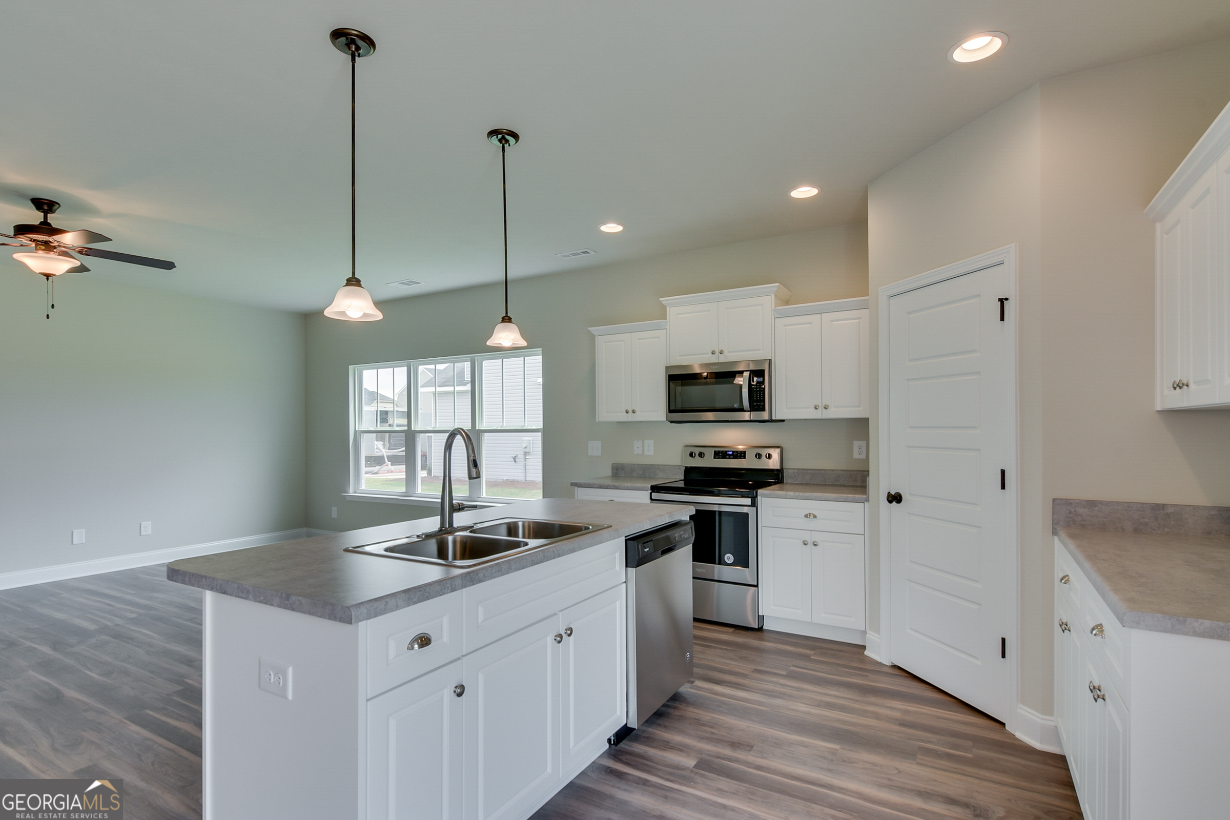0 Orchard Circle Edgefield, SC 29824 - Photo 2 of 10 a kitchen with stainless steel appliances kitchen island granite countertop a sink a stove a refrigerator and island with wooden floor