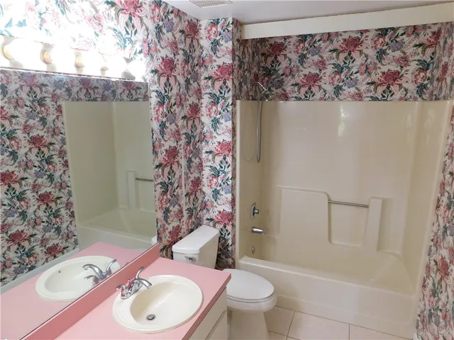 a bath room with a toilet and a shower curtain