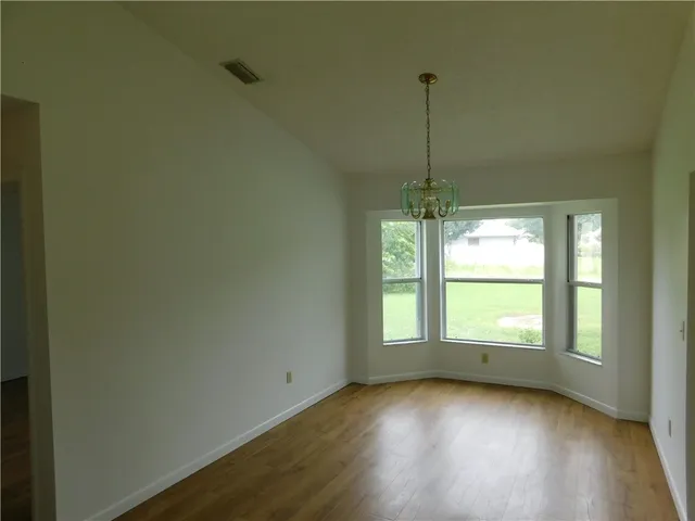 a view of a room window and wooden floor