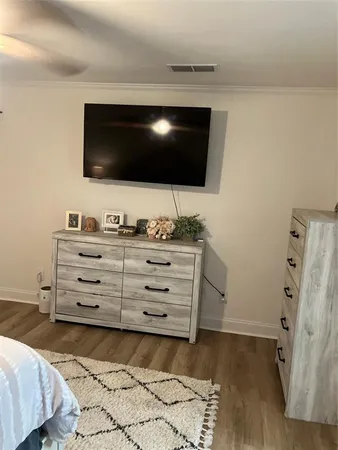 a room with a flat screen tv and cabinets
