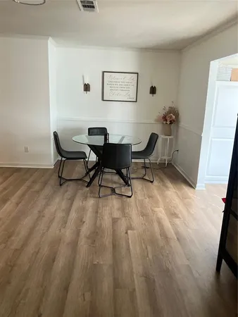 a view of a workspace with furniture and wooden floor