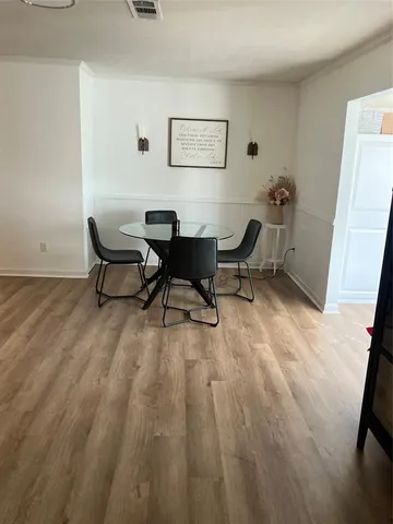 a view of a workspace with furniture and wooden floor