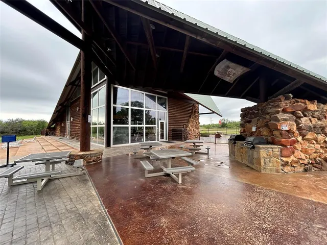 a building outdoor space with patio furniture and potted plants