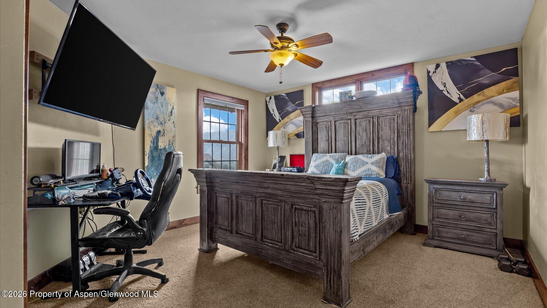829 Ute Circle New Castle, CO 81647 - Photo 23 of 37 a bed room with a bed window and a chandelier