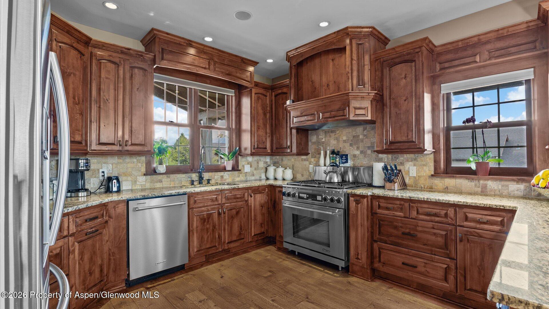 829 Ute Circle New Castle, CO 81647 - Photo 9 of 37 a kitchen with stainless steel appliances granite countertop a stove a sink dishwasher and a refrigerator