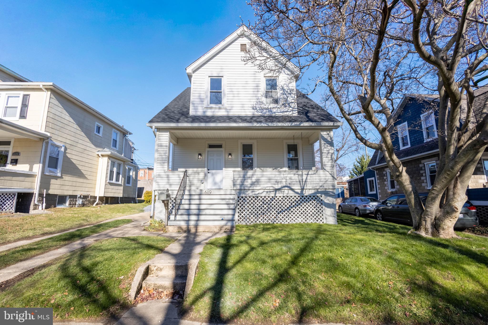 a view of house with yard and sitting area