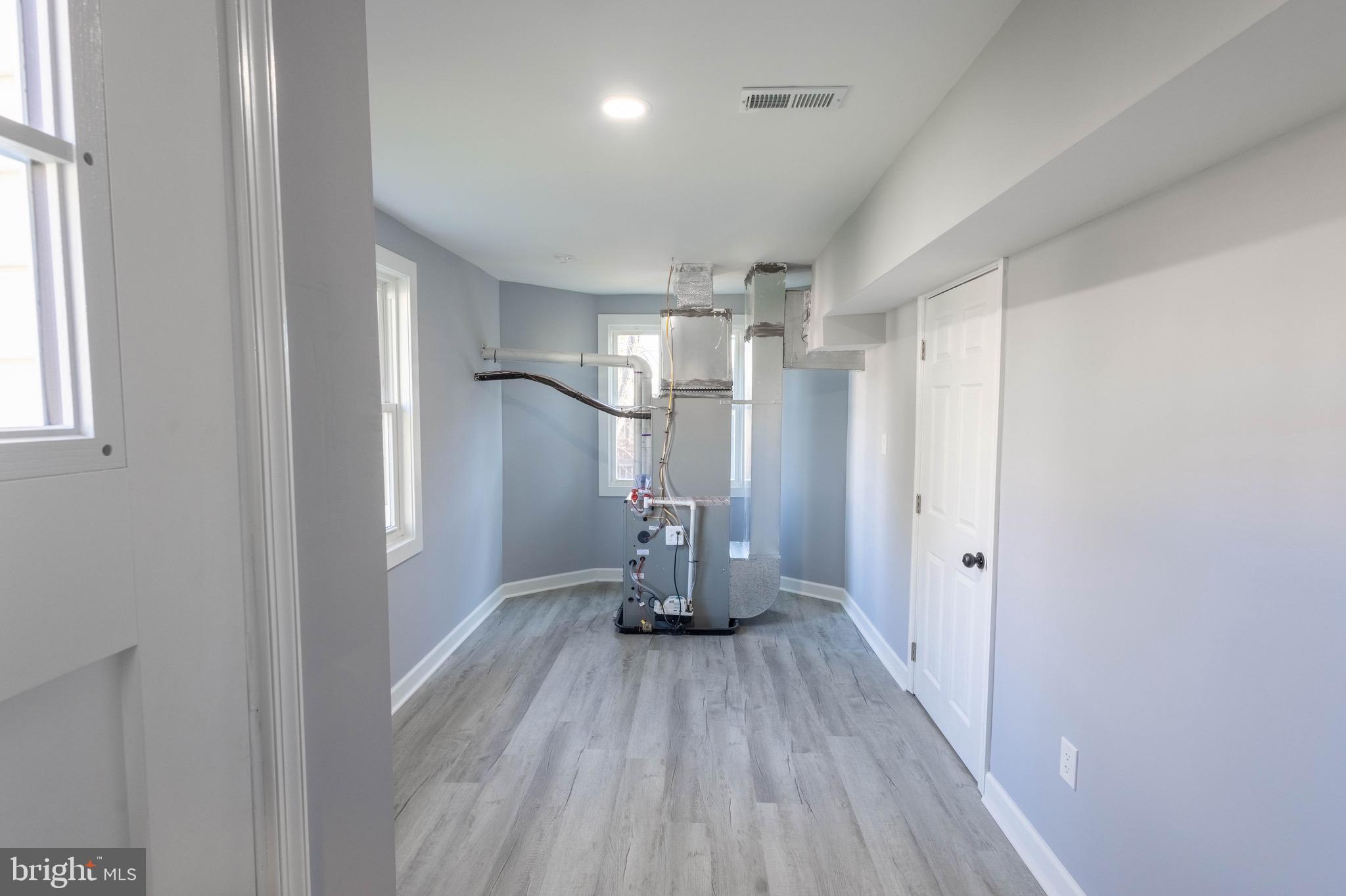 619 Aldershot Road Baltimore, MD 21229 - Photo 11 of 29 a view of a room with wooden floor staircase and a hallway