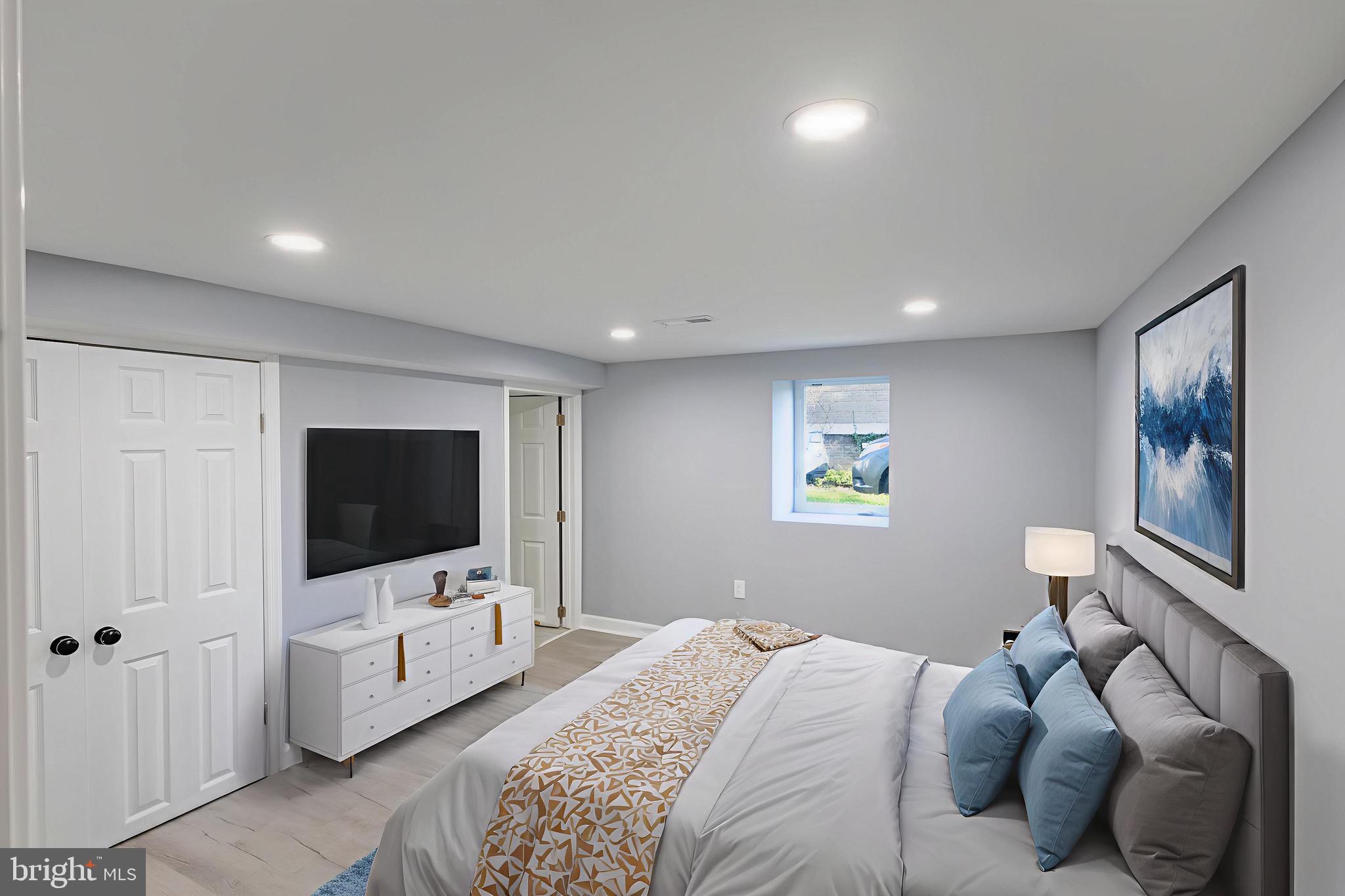 619 Aldershot Road Baltimore, MD 21229 - Photo 15 of 29 a bedroom with a bed and a flat tv screen on dresser