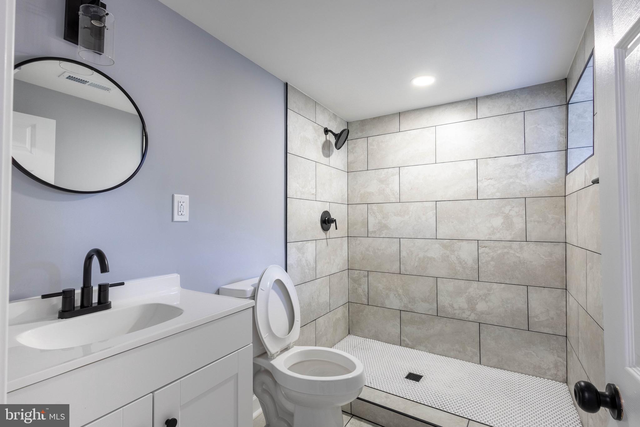 619 Aldershot Road Baltimore, MD 21229 - Photo 17 of 29 a bathroom with a sink toilet and shower