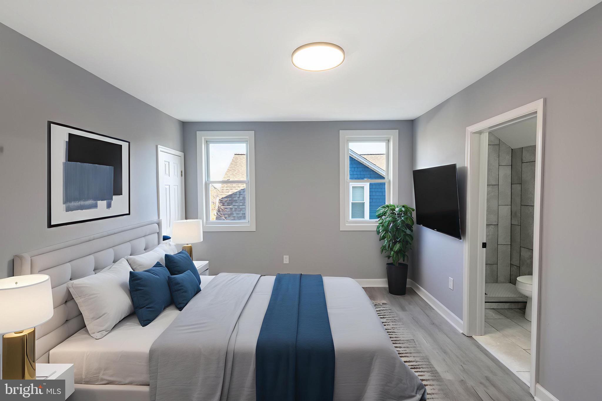 619 Aldershot Road Baltimore, MD 21229 - Photo 19 of 29 a bedroom with a bed and a flat screen tv