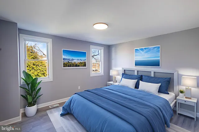 a bedroom with bed and painting on the wall