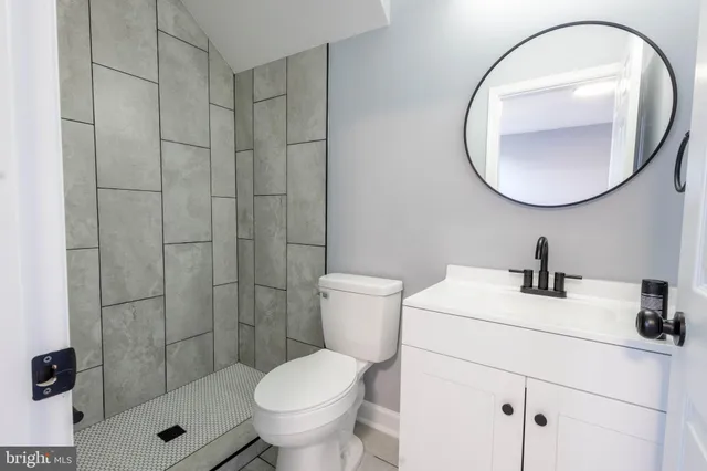 a bathroom with a sink toilet and a mirror