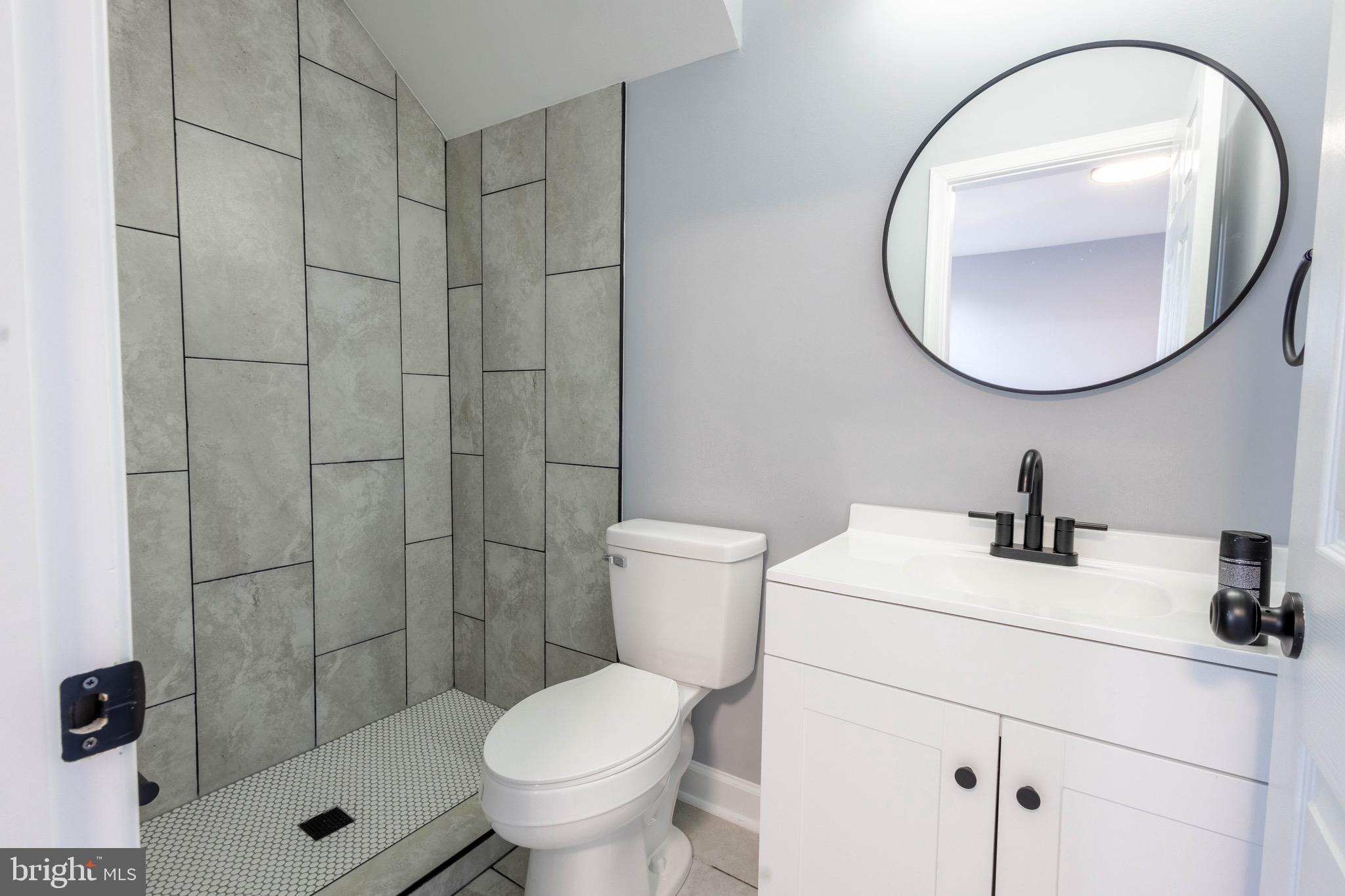 619 Aldershot Road Baltimore, MD 21229 - Photo 25 of 29 a bathroom with a sink toilet and a mirror