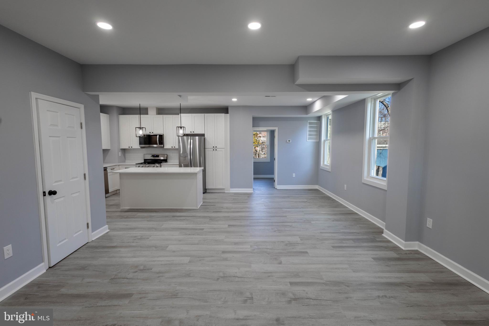 619 Aldershot Road Baltimore, MD 21229 - Photo 4 of 29 a view of a electric appliances in kitchen and empty room with wooden floor