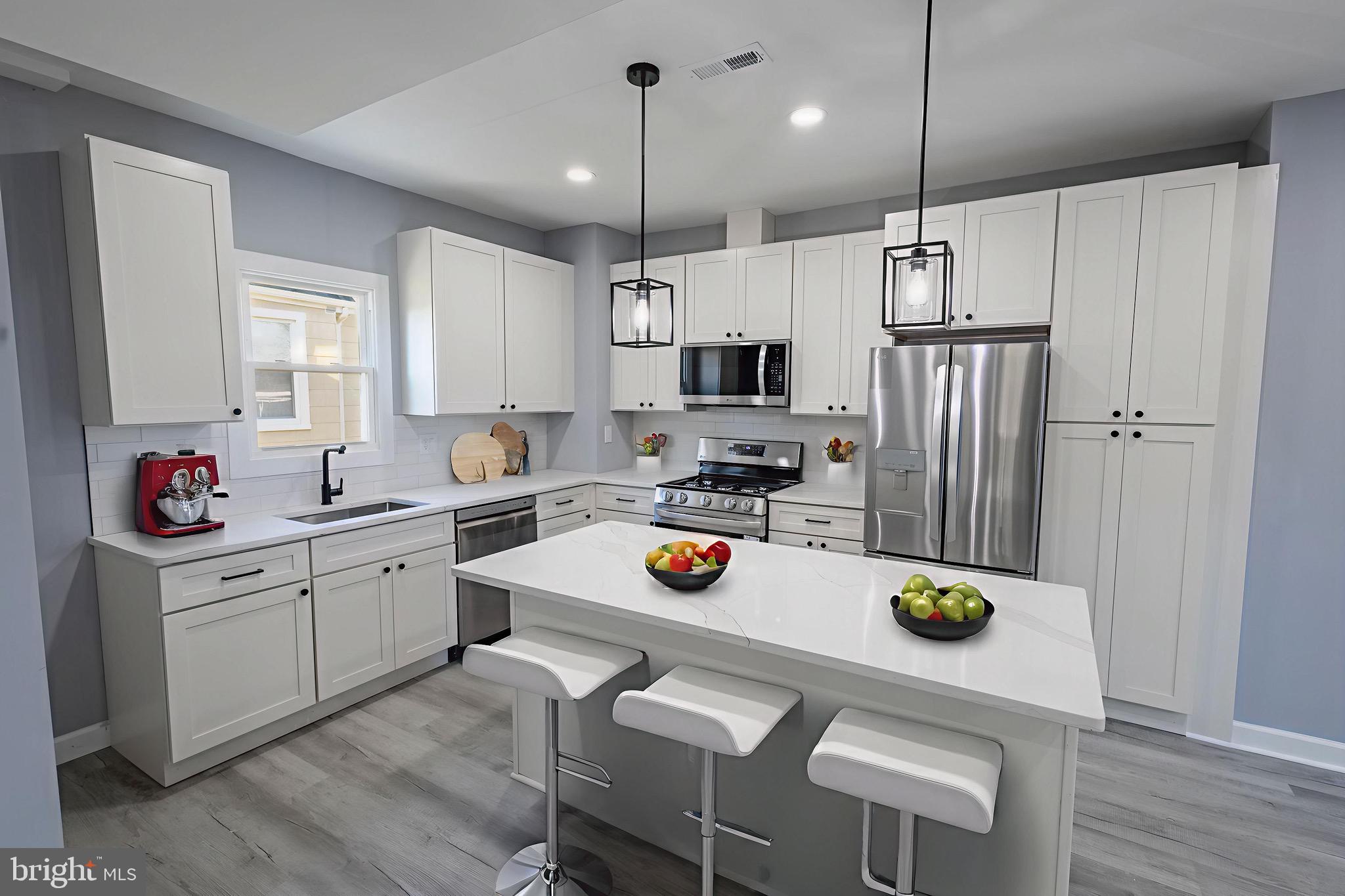 619 Aldershot Road Baltimore, MD 21229 - Photo 6 of 29 a kitchen with a sink a stove and chairs