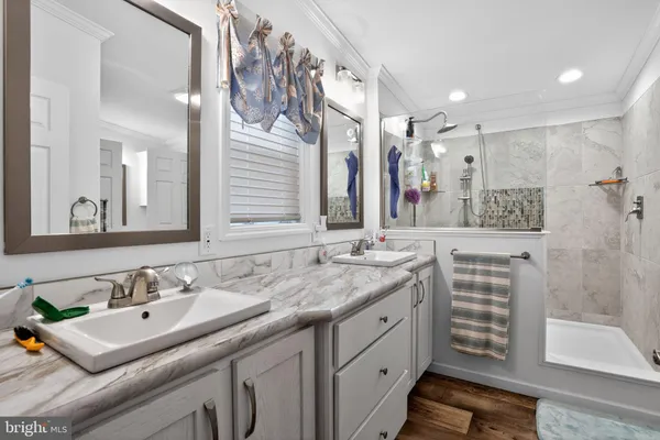 a bathroom with a sink double vanity and a mirror