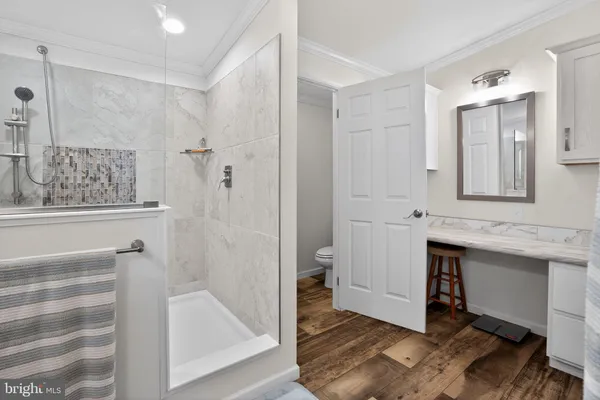 a spacious bathroom with a shower and a sink